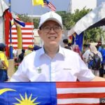 DAP MP for Bagan Lim Guan Eng holding a Malaysian flag
