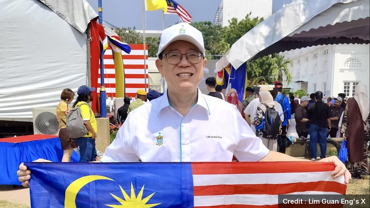 DAP MP for Bagan Lim Guan Eng holding a Malaysian flag