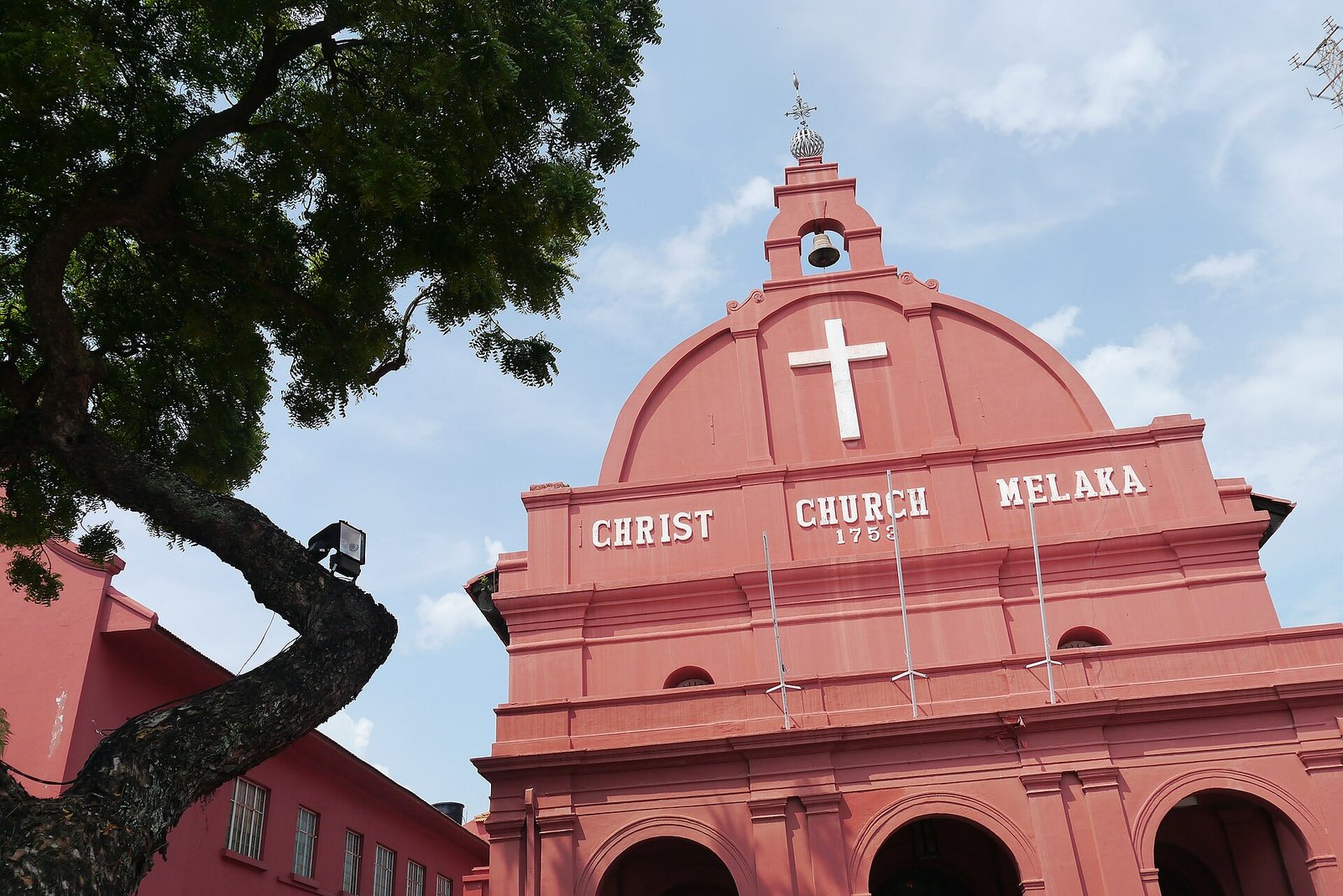 The red facade of Christ Church Melaka, built in 1753, against a blue sky